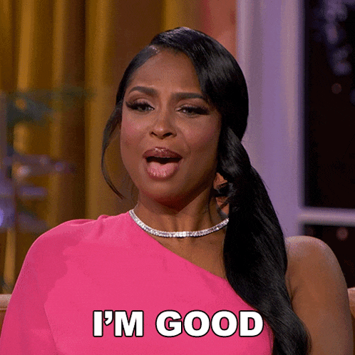 a woman in a pink dress says i 'm good with her tongue out