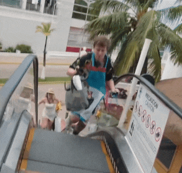 an escalator with a sign that says precaution caution on it