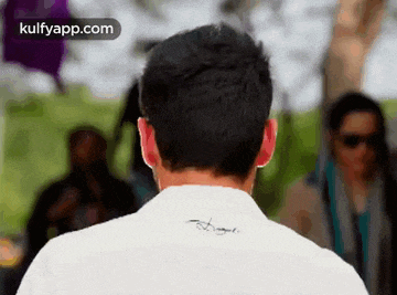 the back of a man 's shirt has a signature on it