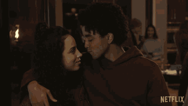 a man and a woman looking into each other 's eyes with a netflix logo in the background