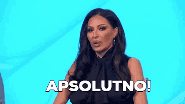 a woman in a black dress is standing in front of a blue background and says apsolutno !