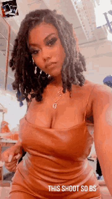 a woman with dreadlocks is taking a selfie with the caption this shoot so bs .