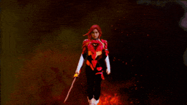 a woman with red hair is wearing a red suit with a heart cut out of it .