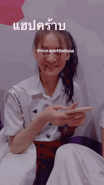 a girl with a bandage on her face has the name nine.bnk48official on the bottom