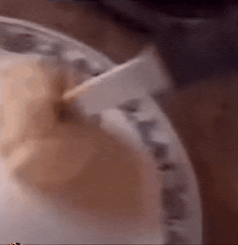 a close up of a paper plate with a spoon on it