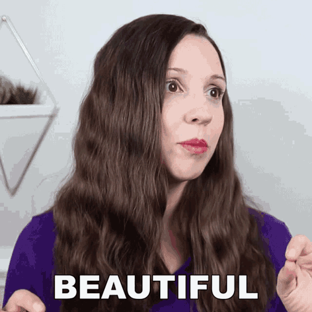 a woman in a purple shirt has the word beautiful written on her face