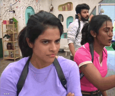 a woman wearing a purple shirt with a strap that says ' dr ' on it