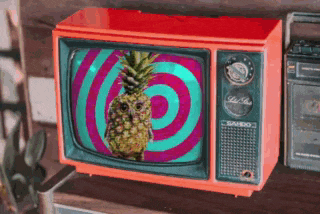a pineapple on the screen of an old fashioned television