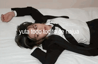 a man in a suit and tie is laying down on a bed