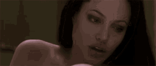 a close up of a woman 's face with a blurred background .