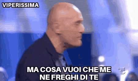 a bald man in a suit and tie says ma cosa vuoi che me ne freghi di te