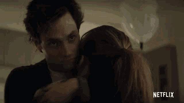 a man and a woman are hugging with netflix written on the bottom right