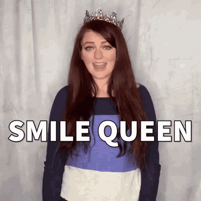 a woman wearing a tiara says smile queen in front of a white wall