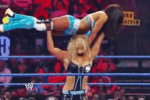 a woman in a wrestling ring with a sign that says field smarts