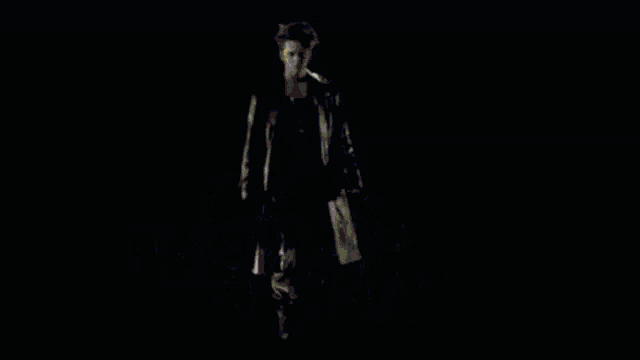 a man in a leather jacket is standing in front of a sign that says christo-oliver von