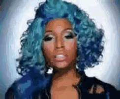 a woman with blue curly hair is wearing a black jacket