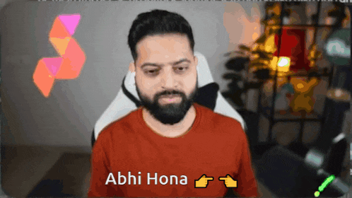a man with a beard is wearing a red shirt that says abhi hona on it