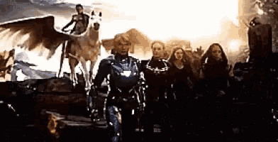 a group of people standing next to each other with a man on a horse with wings .