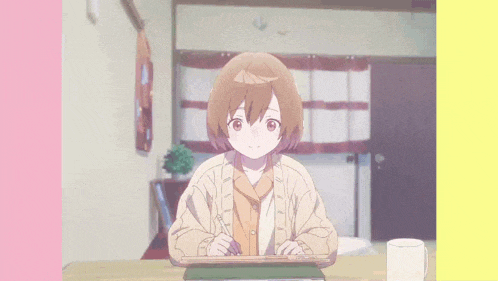 a girl is sitting at a table with a tablet and a pen in her hand .