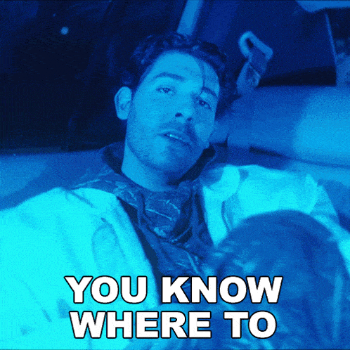a man laying in a car with the words you know where to below him