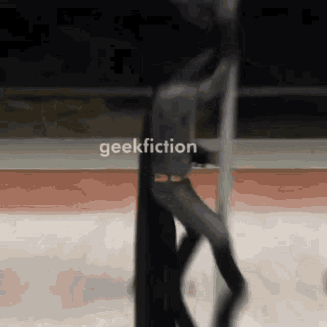 a blurry picture of a person in a batman costume with geekfiction written on the bottom right