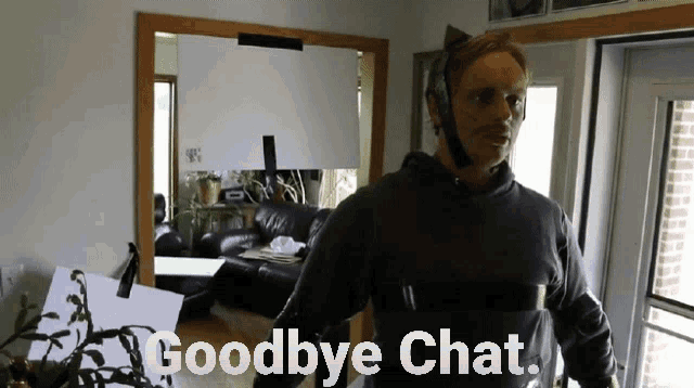 a man in a cat costume says goodbye chat in front of a mirror