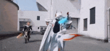a man in a robot costume is standing in front of a building .