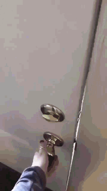 a person is opening a door with a screwdriver