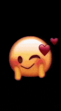 a smiley face with hearts in its eyes is making a heart shape with its hands .