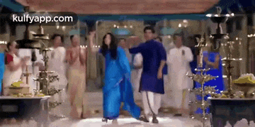 a man and a woman are dancing together in a room .