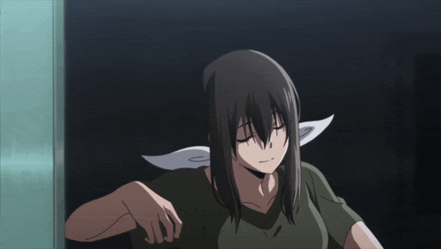 a girl with long hair and a scarf around her neck is standing in a dark room