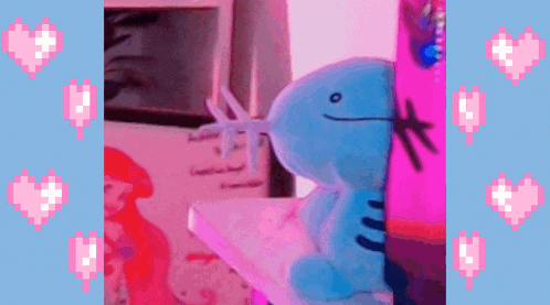 a blue stuffed animal is sitting on a pink and blue shelf