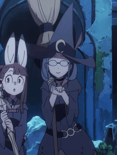 two witches standing next to each other with one wearing a hat with the letter c on it