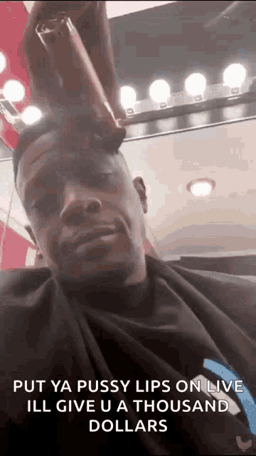 a man is getting his hair cut at a barber shop and says `` put ya pussy lips on live '' .