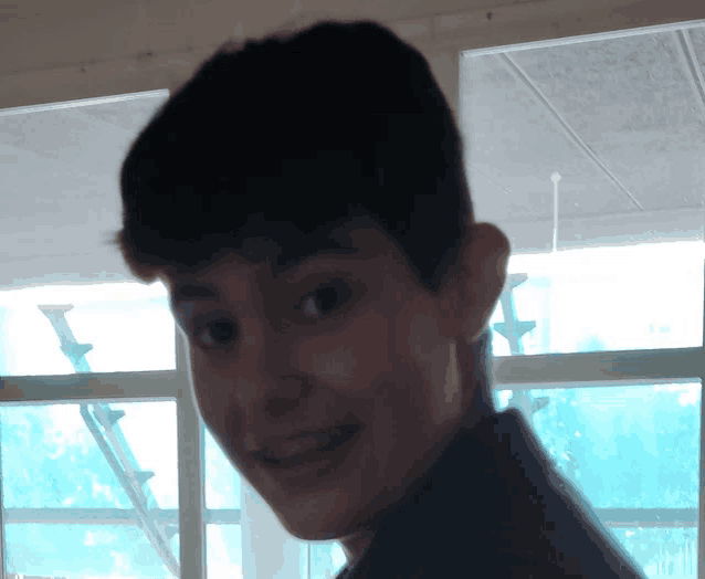 a close up of a person 's face with stairs in the background