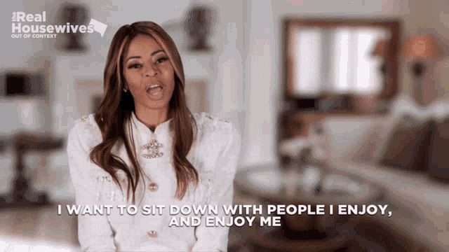 a woman in a white jacket says i want to sit down with people i enjoy and enjoy me