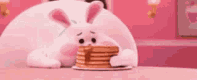 a bunny is eating a stack of pancakes on a pink table .