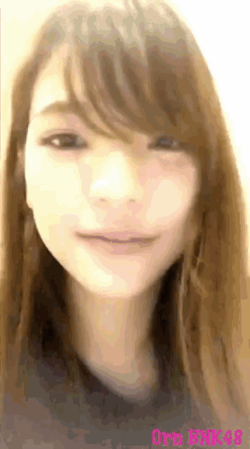 a close up of a woman 's face with a blurred background