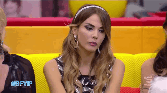 a woman sitting on a couch with gfvip written on the bottom right