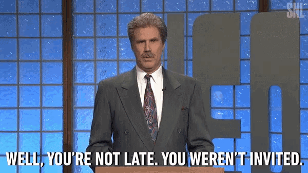 a man in a suit and tie is standing at a podium and saying well you 're not late you weren