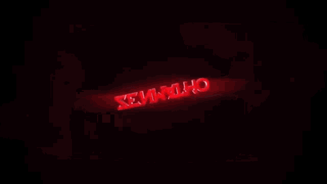 a red light is shining in the dark and looks like a sword