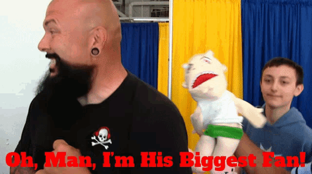 a bald man with a beard is holding a stuffed animal with the words oh man i 'm his biggest fan