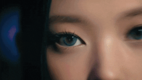 a close up of a woman 's blue eye with long lashes
