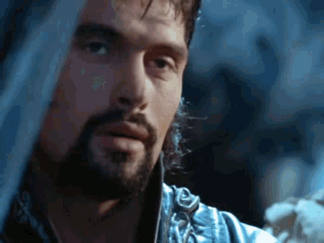 a close up of a man with a beard looking at something