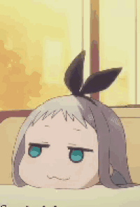 a cartoon girl with a bow on her head is laying down on a couch .