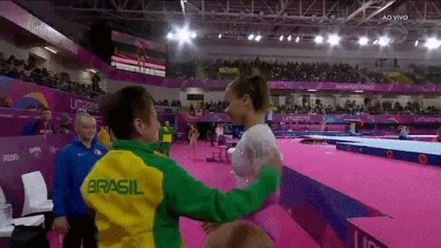 a man in a green and yellow jacket with the word brasil on it