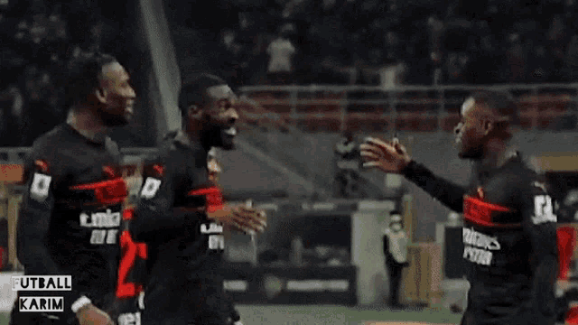 a group of soccer players wearing emirates fly better uniforms