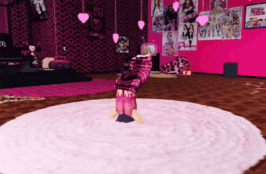 a girl is doing a handstand in a room with posters on the walls that say monster high