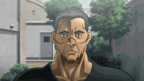 a man in a black shirt is looking at the camera with a serious look on his face