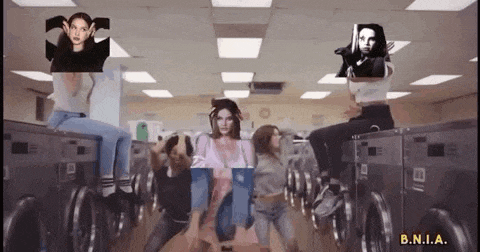 a group of women are dancing in a laundromat .